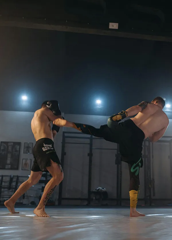 Two men engaged in combat with boxing gloves